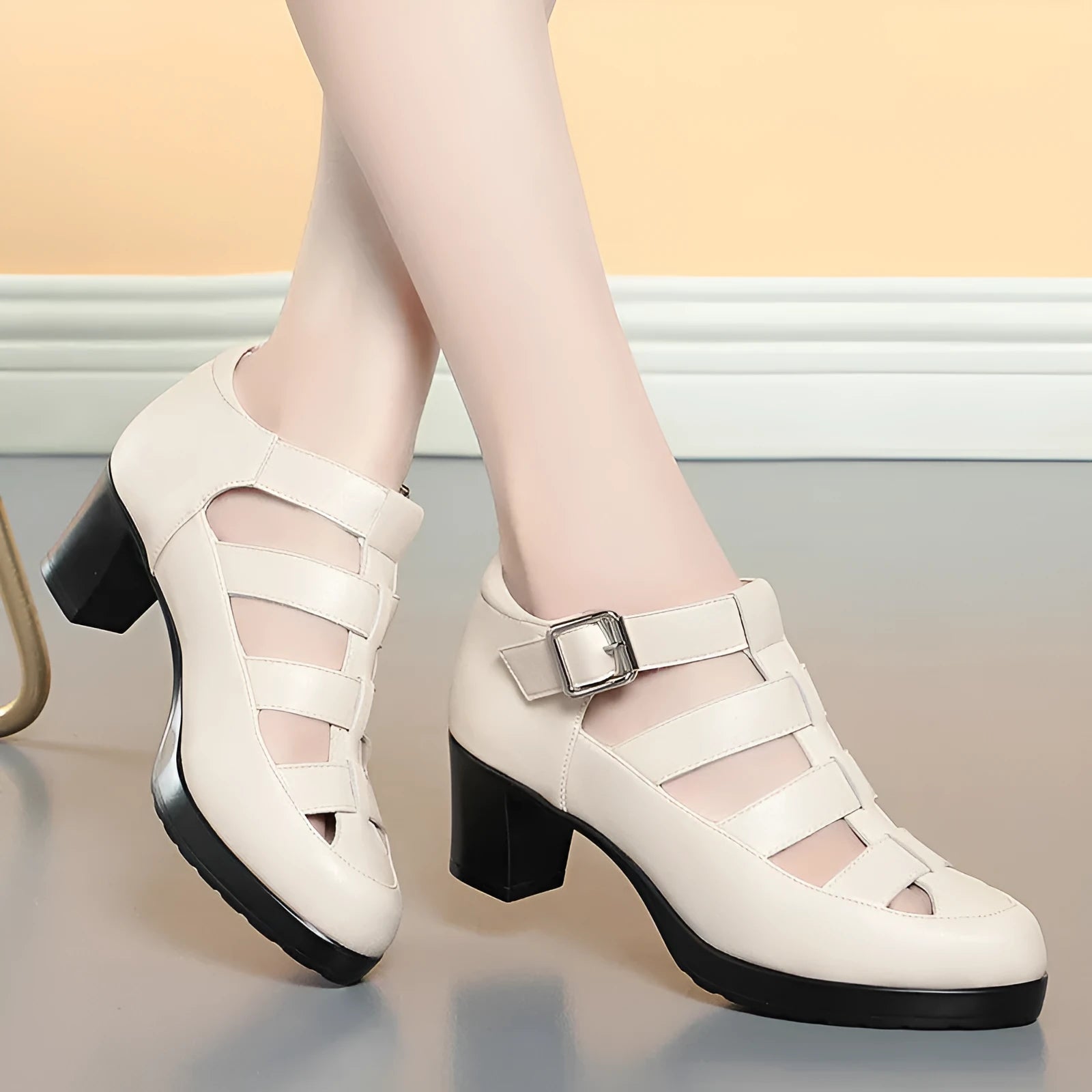 Women's beige closed toe sandals with woven upper, ankle strap, buckle, and back zipper on a chunky heel.
