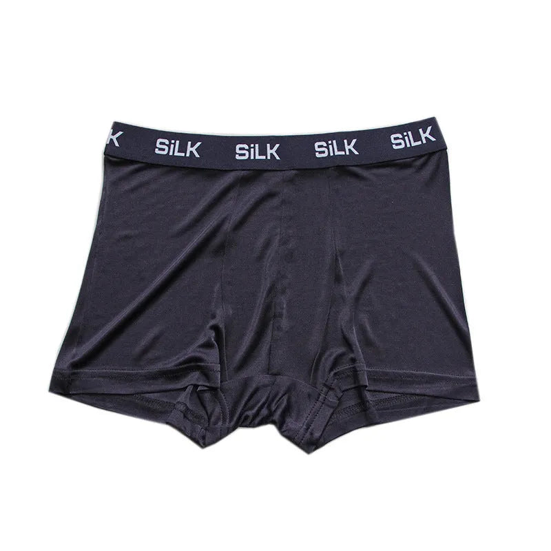 Men's loose fit silk shorts in navy blue, shown on a mid waist.