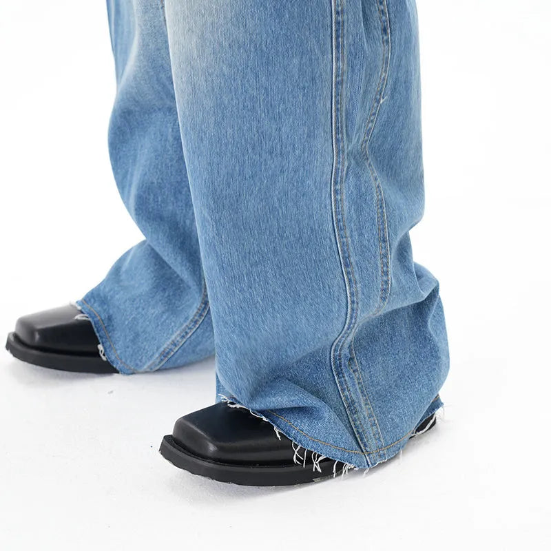 Cut washed vintage washed wide leg machete jeans in light blue denim with zipper fly, front view