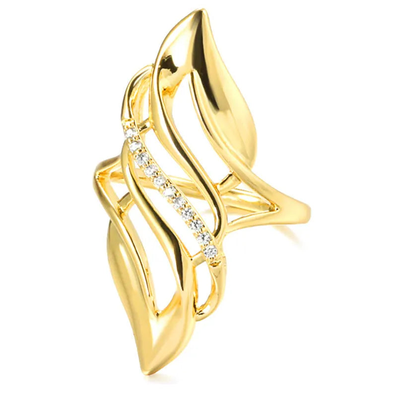 Gold tone exaggerated curve copper ring with zircon stone on white background