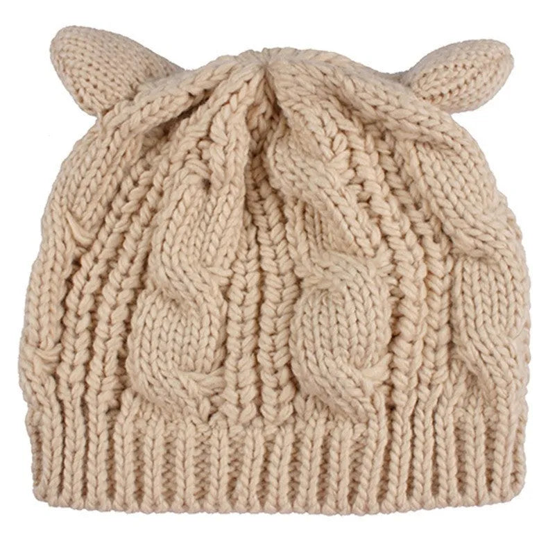 Red handmade knitted wool beanie hat with 3D cat ears on a white background