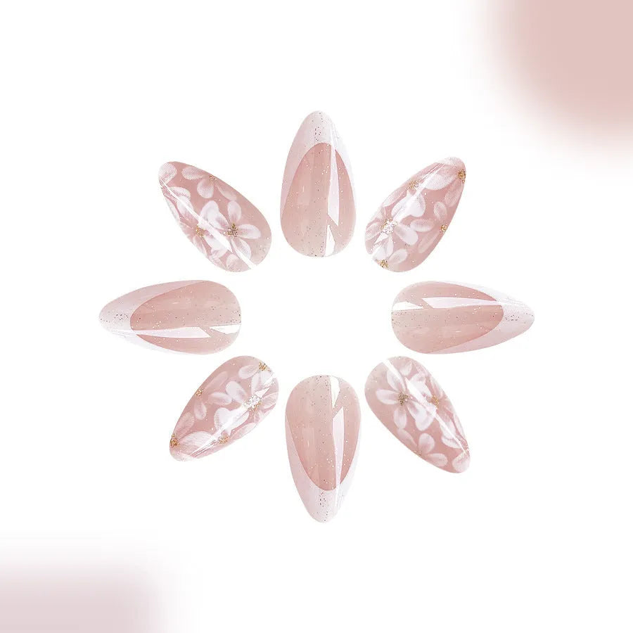 Short almond false nails with French manicure style and glittering floral powder accents in C625 colour