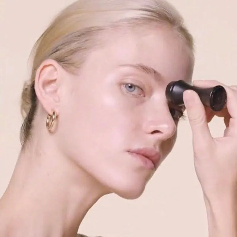Volcanic stone facial roller for oily skin in black, green, pink, or white on a plain background