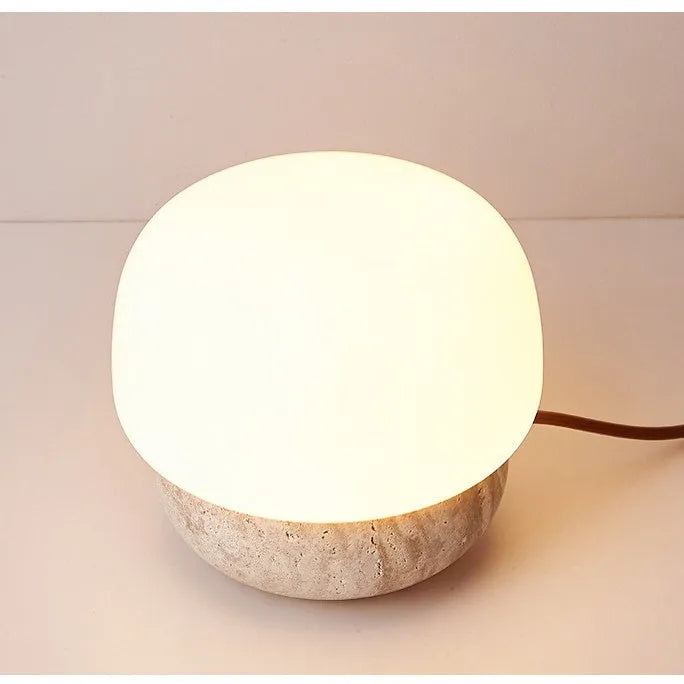 Cream-coloured retro style bedside lamp on a table.