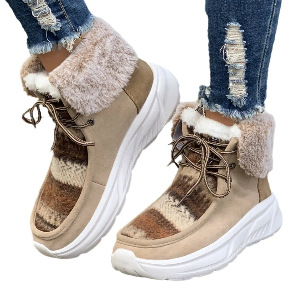 Women's beige suede lace-up snow boots with a thick rubber sole and plush lining on a white background.