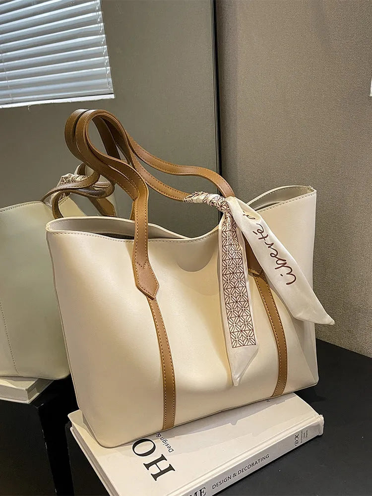 Women's large capacity soft tote bag in multiple colour options showing bucket design and crossbody strap