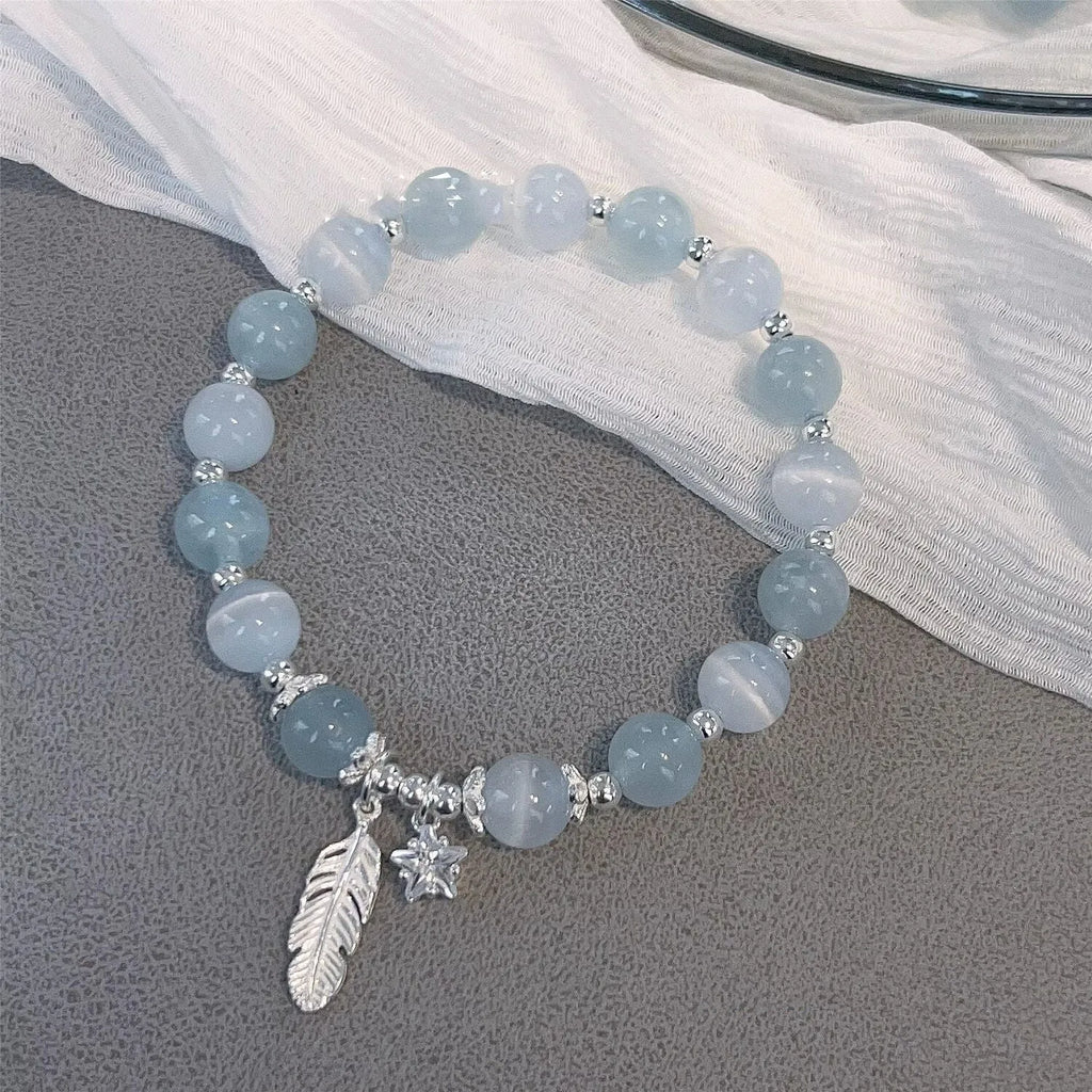 Small white girl crystal bracelet in Feather XINGX Blue Moonlight with eight Awn star and text design