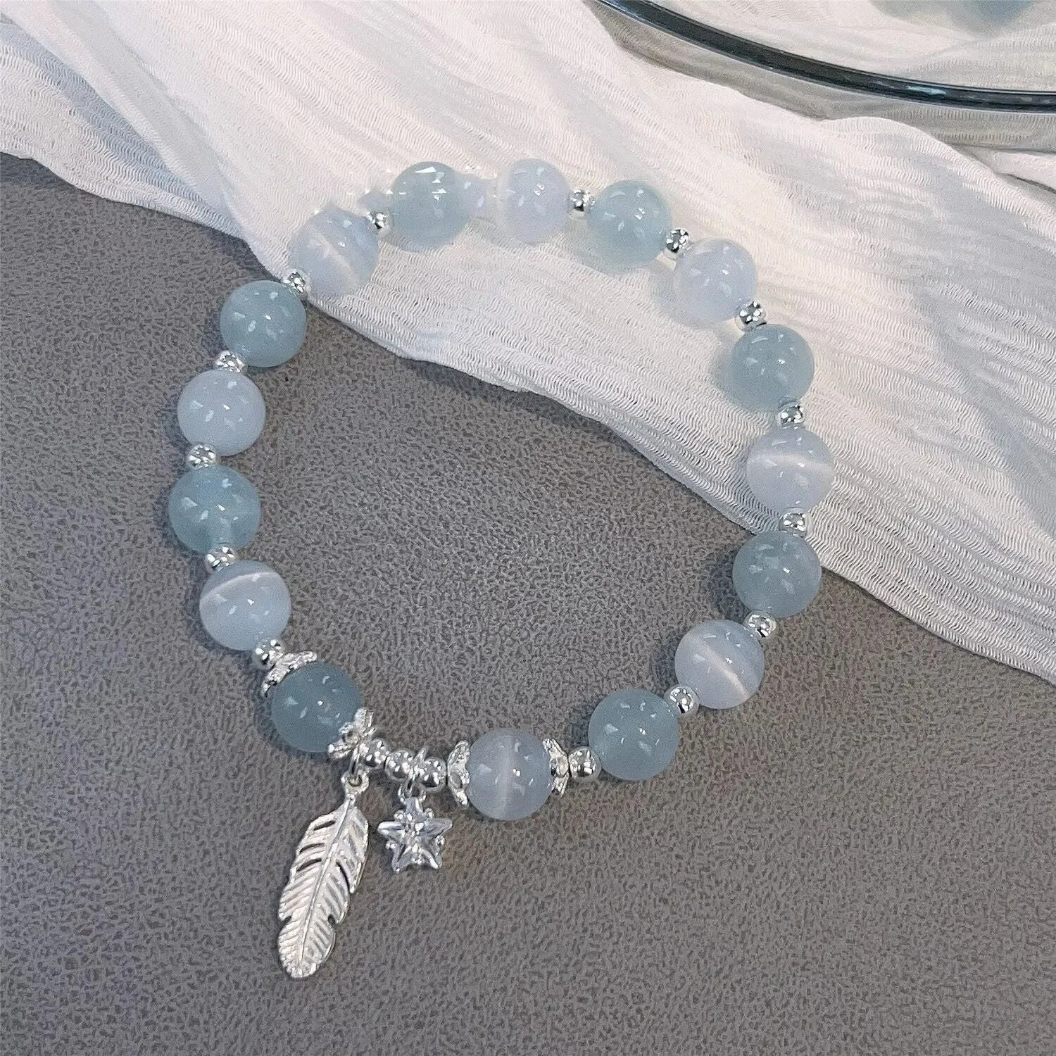 Small white girl crystal bracelet in Feather XINGX Blue Moonlight with eight Awn star and text design