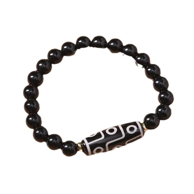 Ethnic style Tibet dzi bead bracelet in obsidian agate, unisex couple design on a neutral background