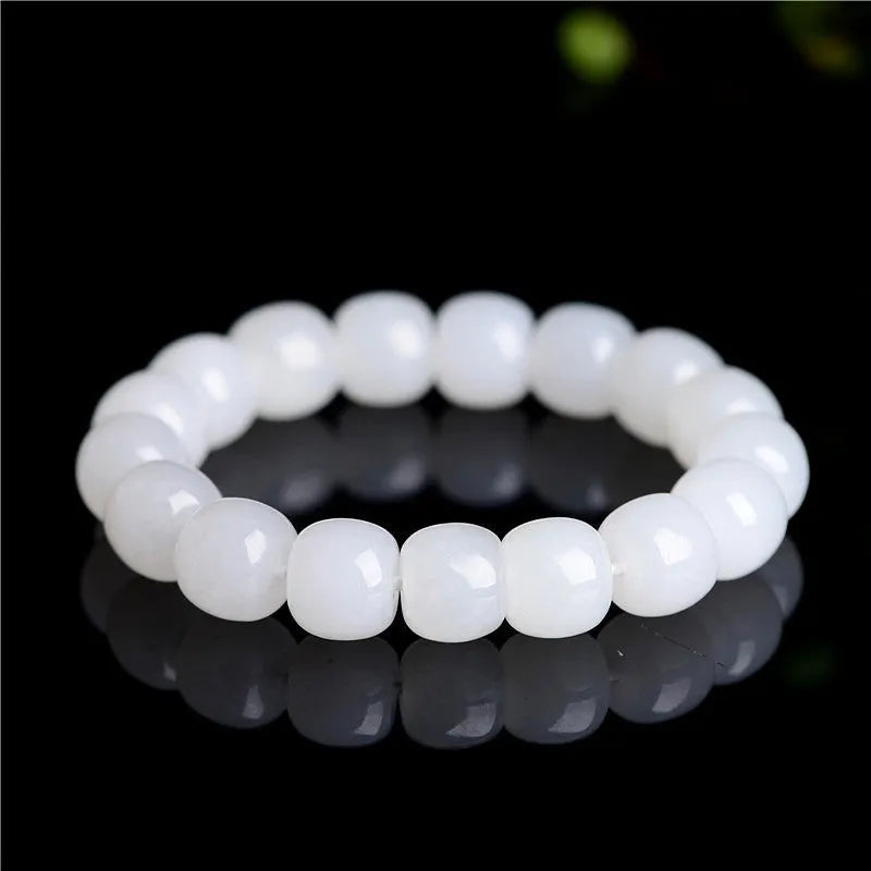 White Hetian jade barrel bead bracelet on a wrist, showing the unisex casual design.