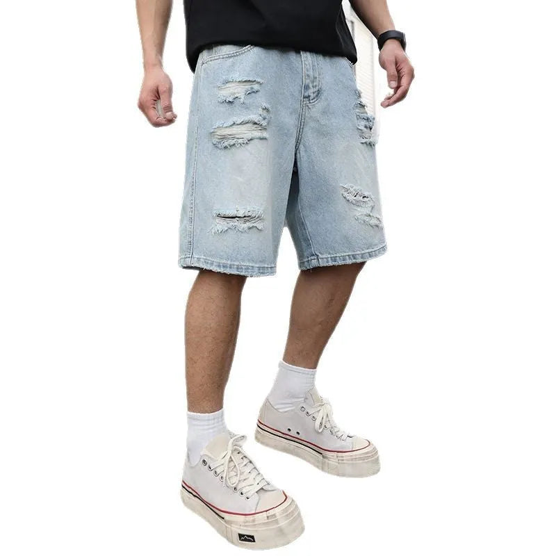 Light blue ripped denim shorts with distressed detailing and loose straight leg fit