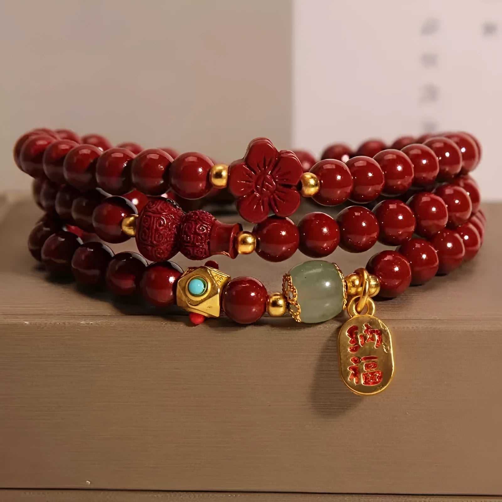 Multi-circle cinnabar bracelet with gourd and five petal flower motifs, polished finish, 6mm beads