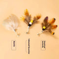 Three steel wire cat toy replacement heads with small flying insect designs in varied colours