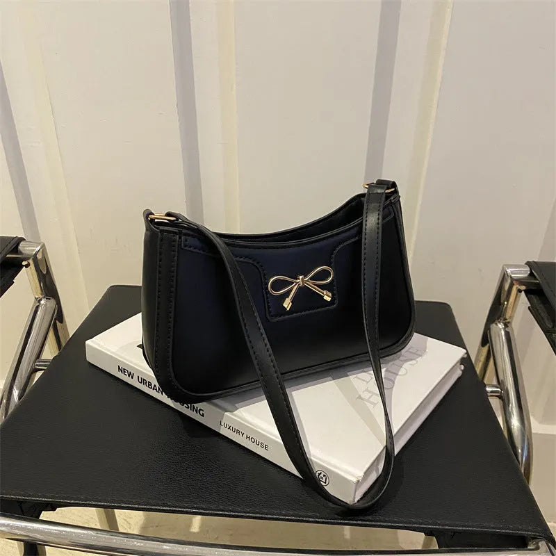 PU leather baguette bag with bow decoration in rose red colour, 24x14x5 cm size on white background