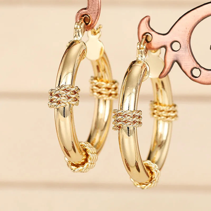 Geometric copper earrings for women with ring and line details in golden colour.