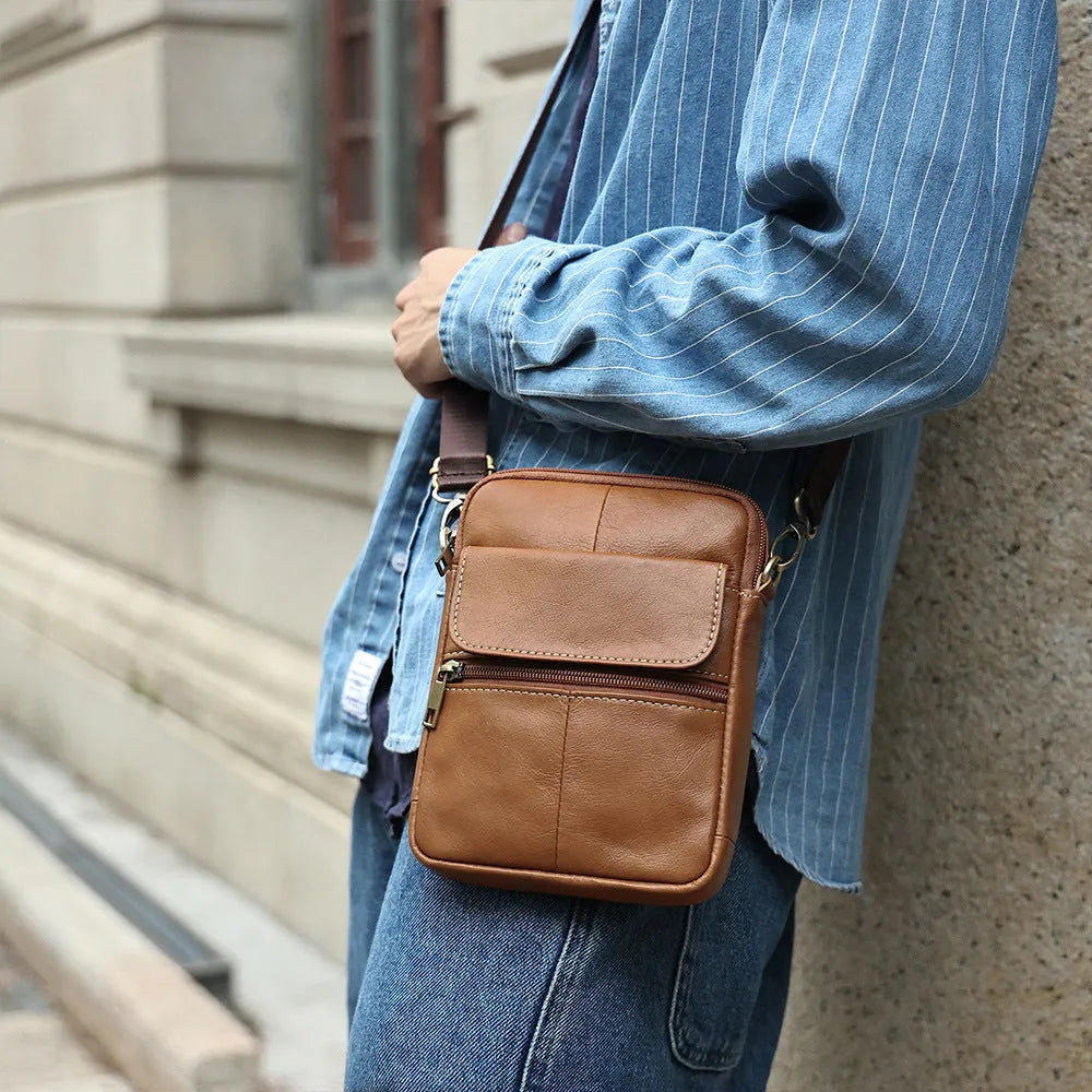 Men's brown genuine leather crossbody shoulder bag with sewing line details.