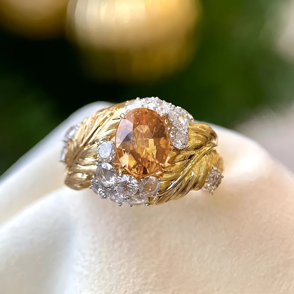 Gold copper feather ring with embossed design and yellow zircon stone in geometric setting