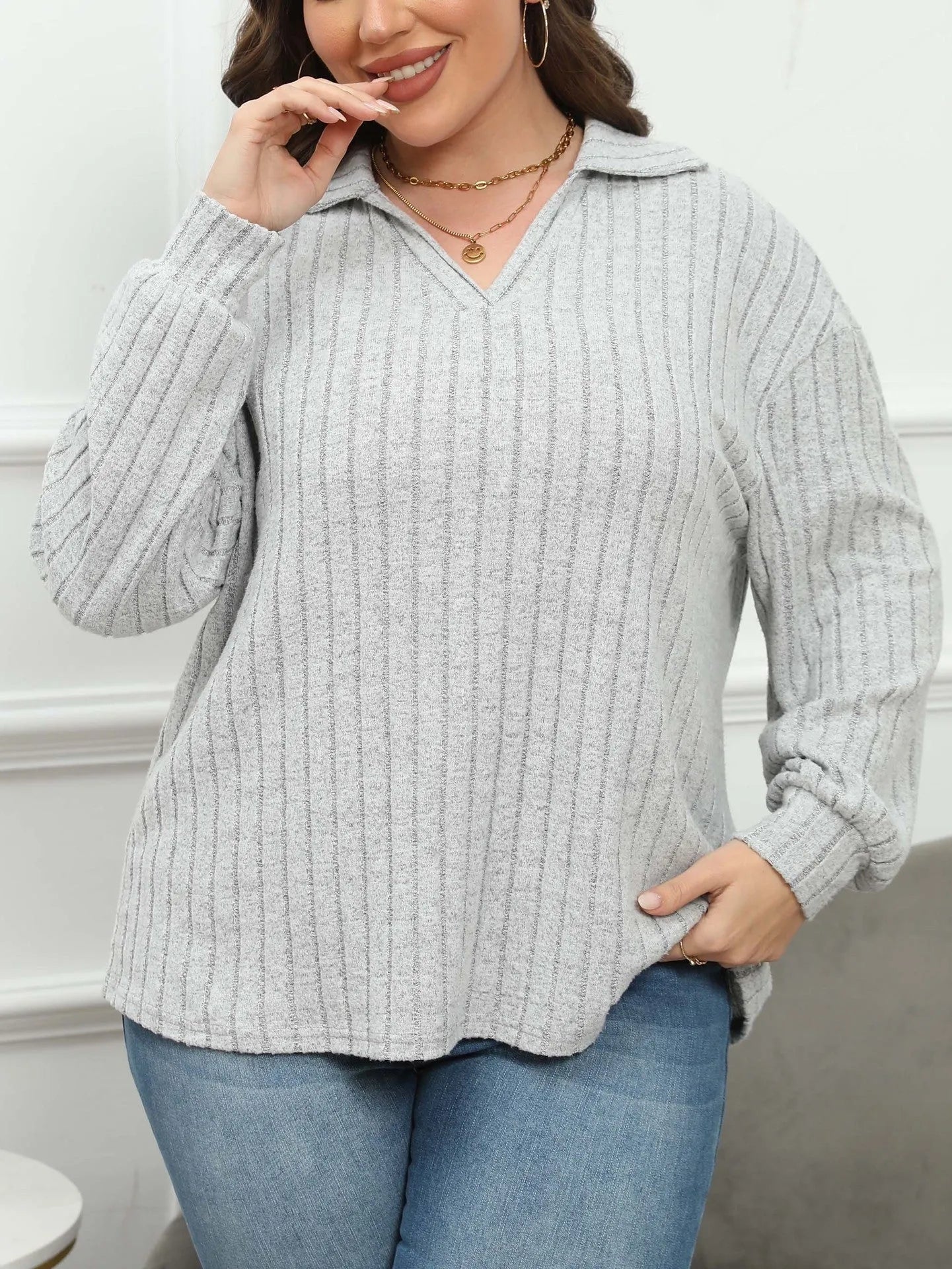 Women's plus size gray polo collar shirt with full lantern sleeves in a street fashion style.