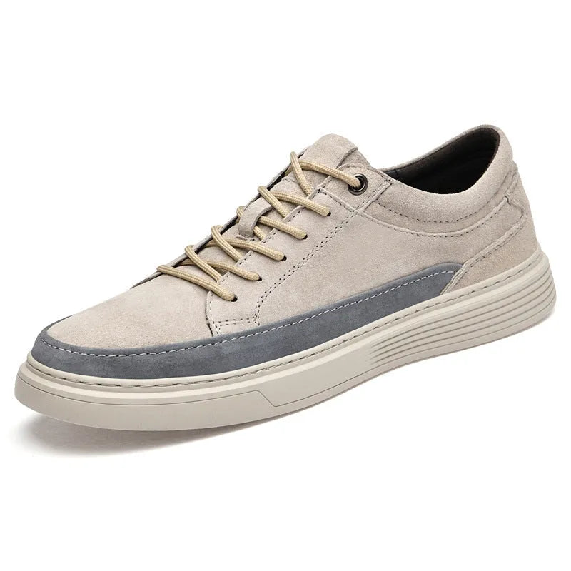 Men's grey low-top casual skate shoes with a pigskin leather upper and rubber sole.