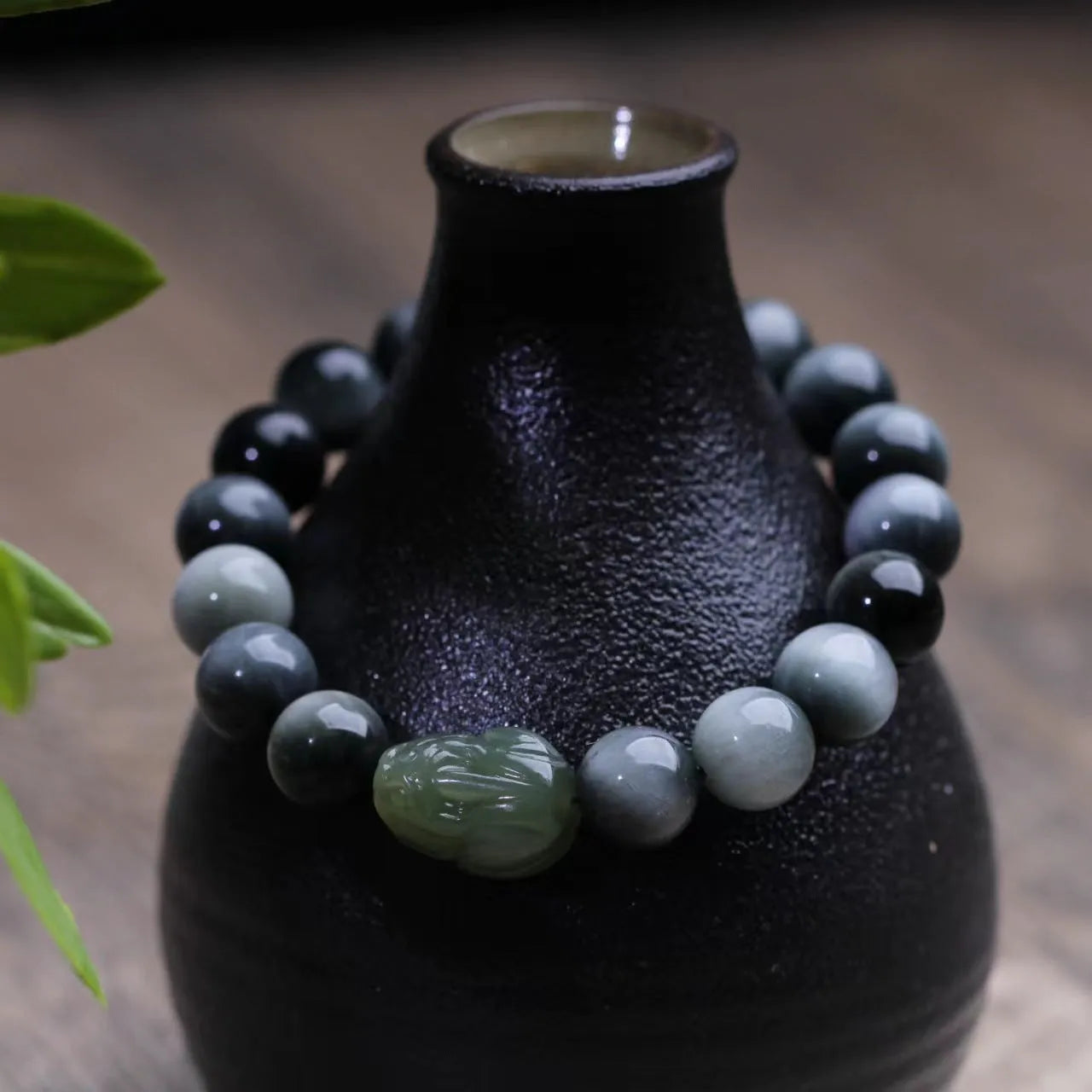 10mm black eagle eye stone and natural Hetian jade clear water Pixiu bracelet on a neutral background
