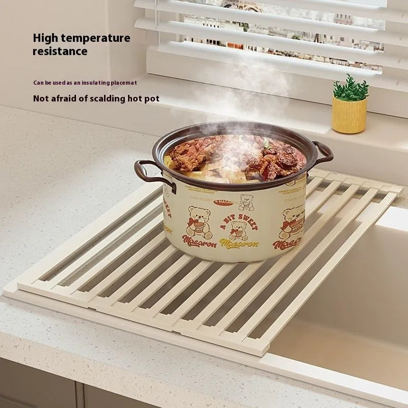 Milky white foldable stainless steel draining rack showing tri-fold design with dishes