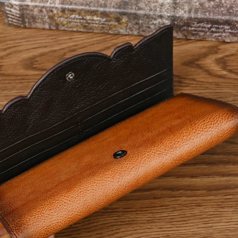 Chinese style embossed leather wallet in tri-fold design showing floral pattern on brown cowhide