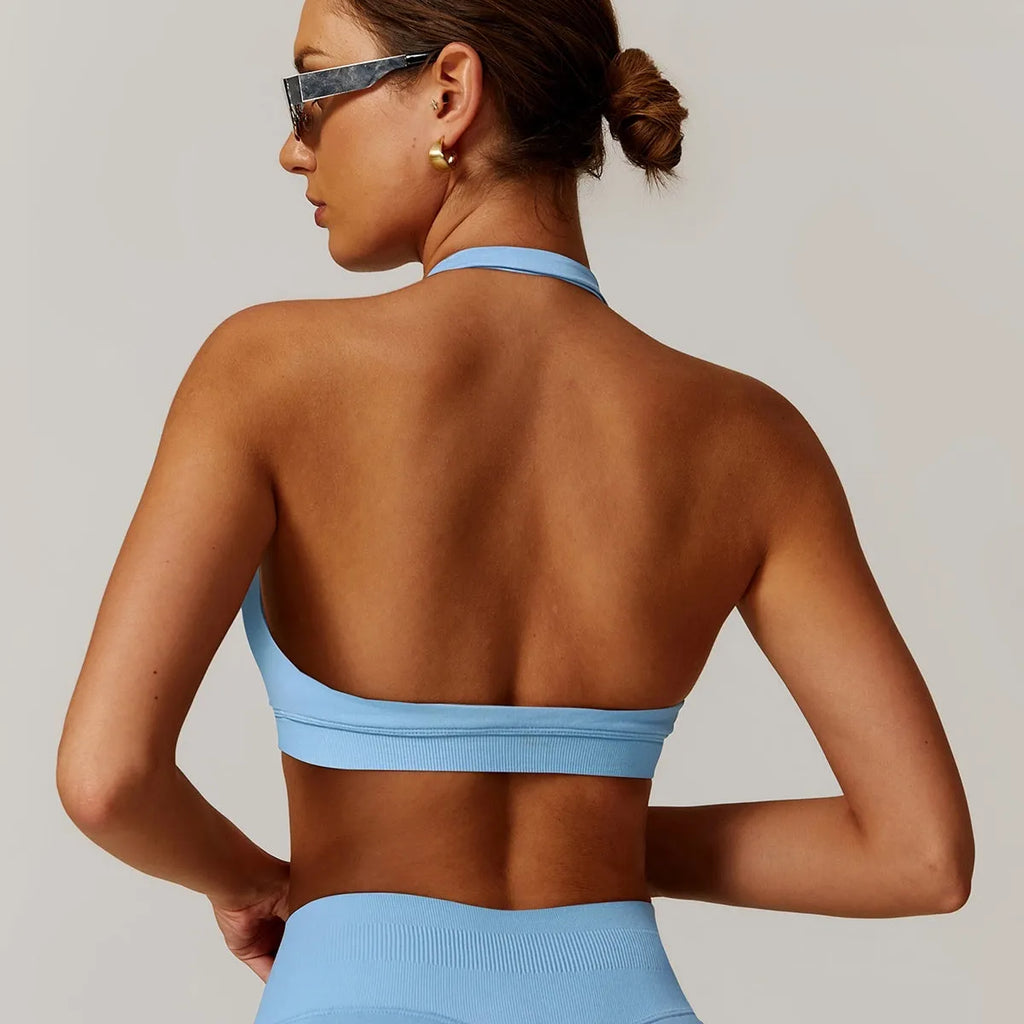 Women's halter style sports bra in black with medium support and built-in chest pads