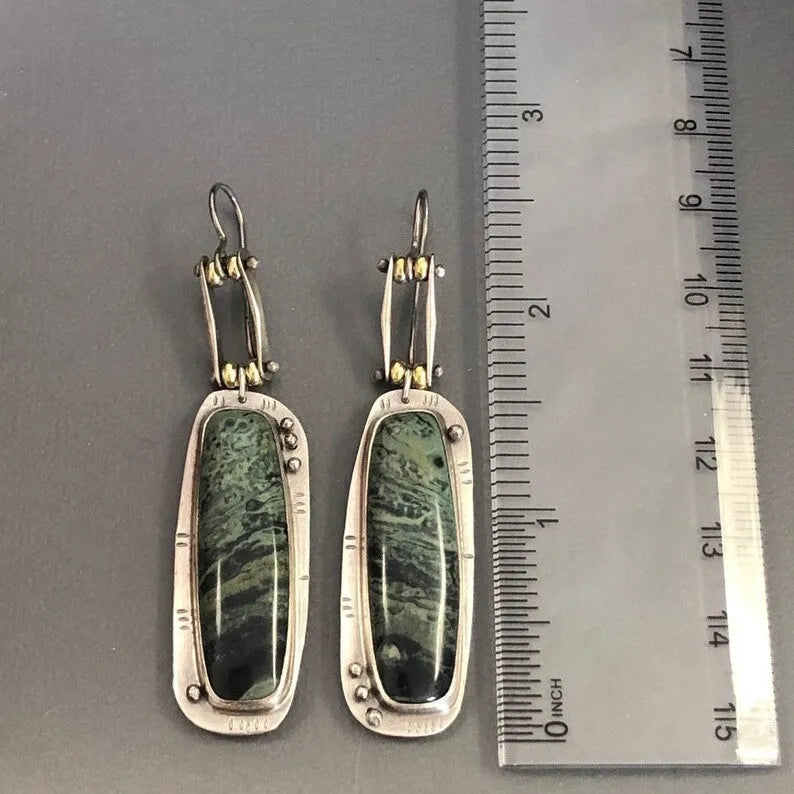 Simple geometric alloy earrings with a two-colour marble pattern and stainless steel posts.