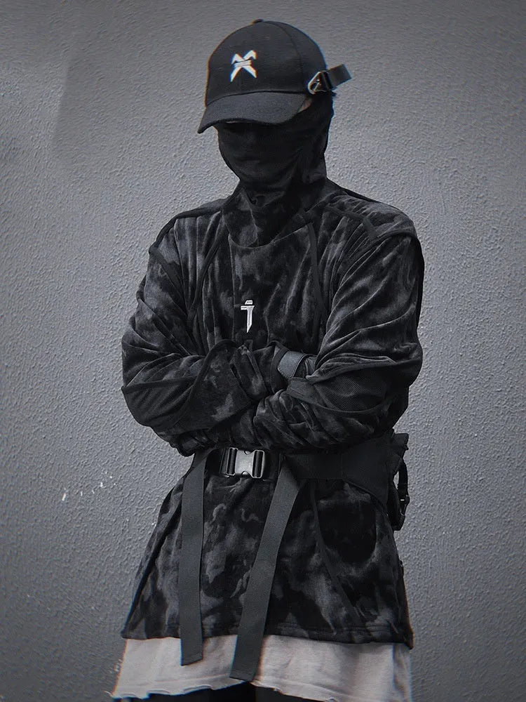 Man wearing a black tie-dye printed pullover sweater with drop shoulders and long sleeves.