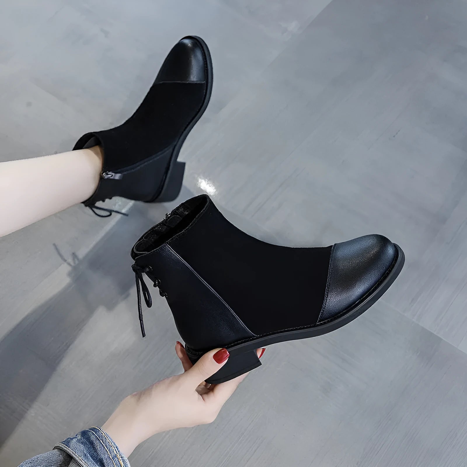 Black women's knee-high Martin boots with side zip, bow detail, and a round toe on a non-slip rubber sole.
