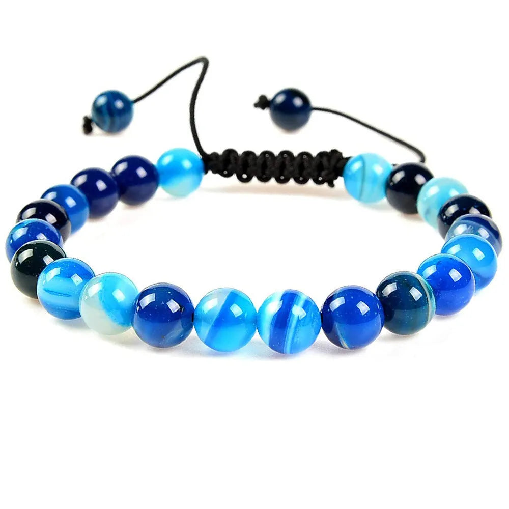 Women's flat knot braided healing bracelet with natural aquamarine stone, hand-woven geometric design on white background