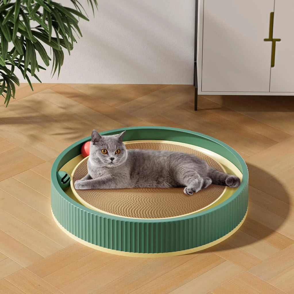 Large circular cat scratching board with integrated ball toys on green background