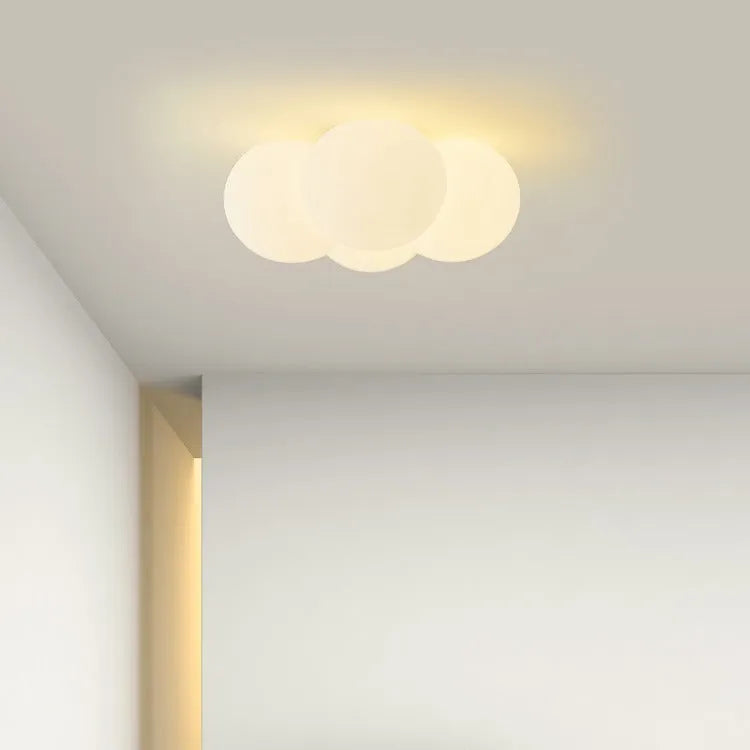 Modern minimalist cloud chandelier with tricolor light, 42mm diameter, ceiling mounted in a bedroom