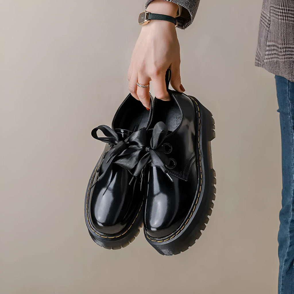 Women's black leather shoes with thick sole and cross-strap design