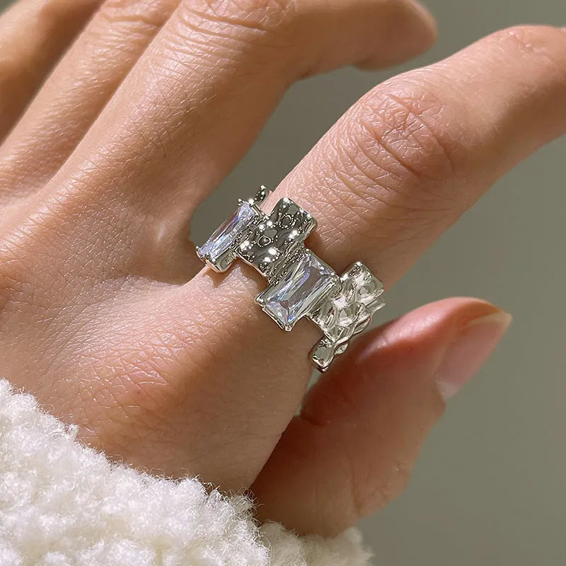 Silver geometric cross ring with zircon detail and open retro design