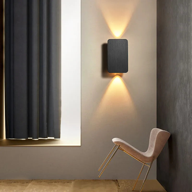 Minimalist modern Nordic metal LED wall lamp in black, mounted on a wall.