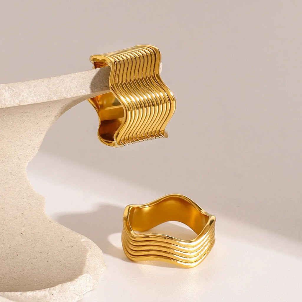Stainless steel wide band finger ring with a geometric wave pattern, electroplated finish.