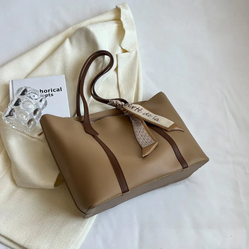 Women's large capacity soft tote bag in multiple colour options showing bucket design and crossbody strap