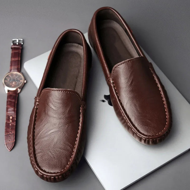 Mens brown casual driving shoes with leather upper, round toe, and stitching detail on a white background