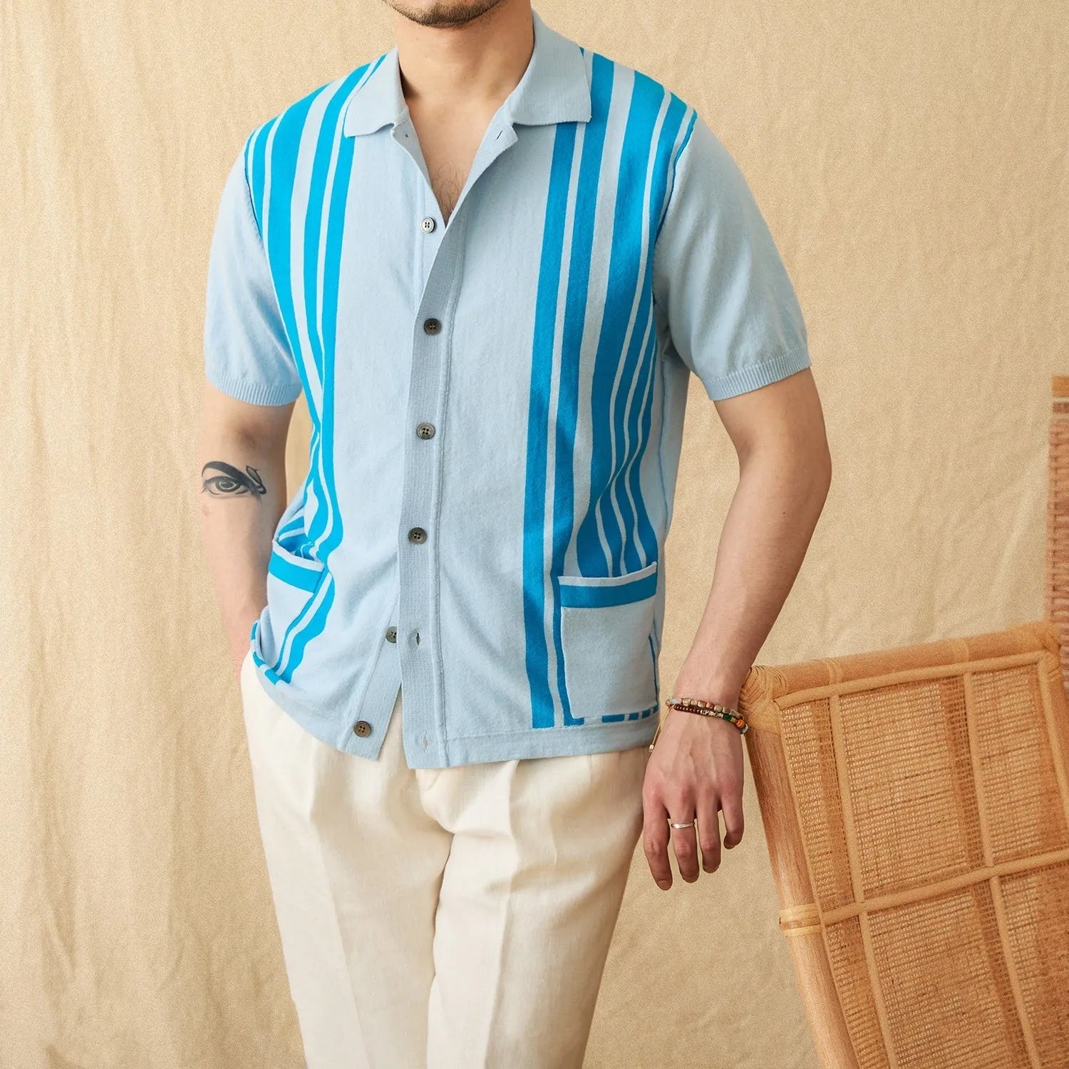 Royal blue striped short-sleeve polo cardigan with a lapel collar on a hanger.