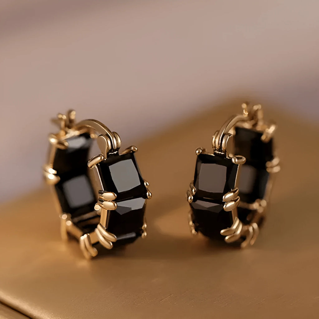 Geometric U-shaped gold earrings with round black zircon crystals