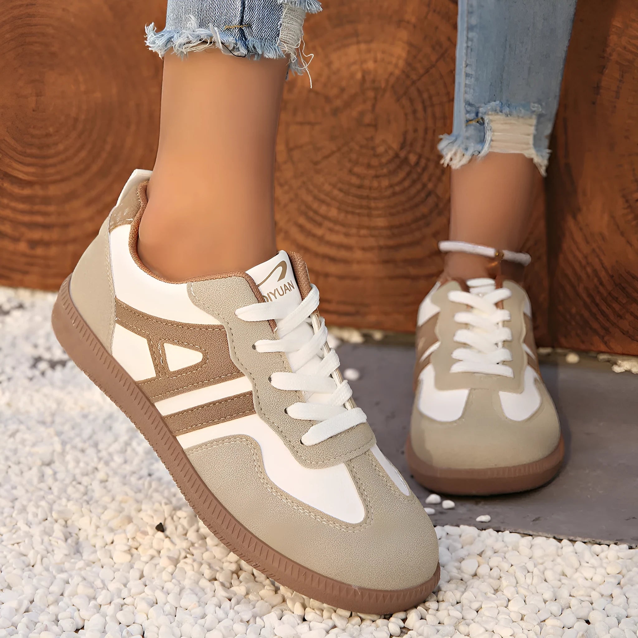 Women's retro lace-up jogging shoes in grey with a colour-matched cross strap and platform sole.
