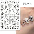 Black and silver strip pattern nail art stickers with cartoon designs on plastic backing.