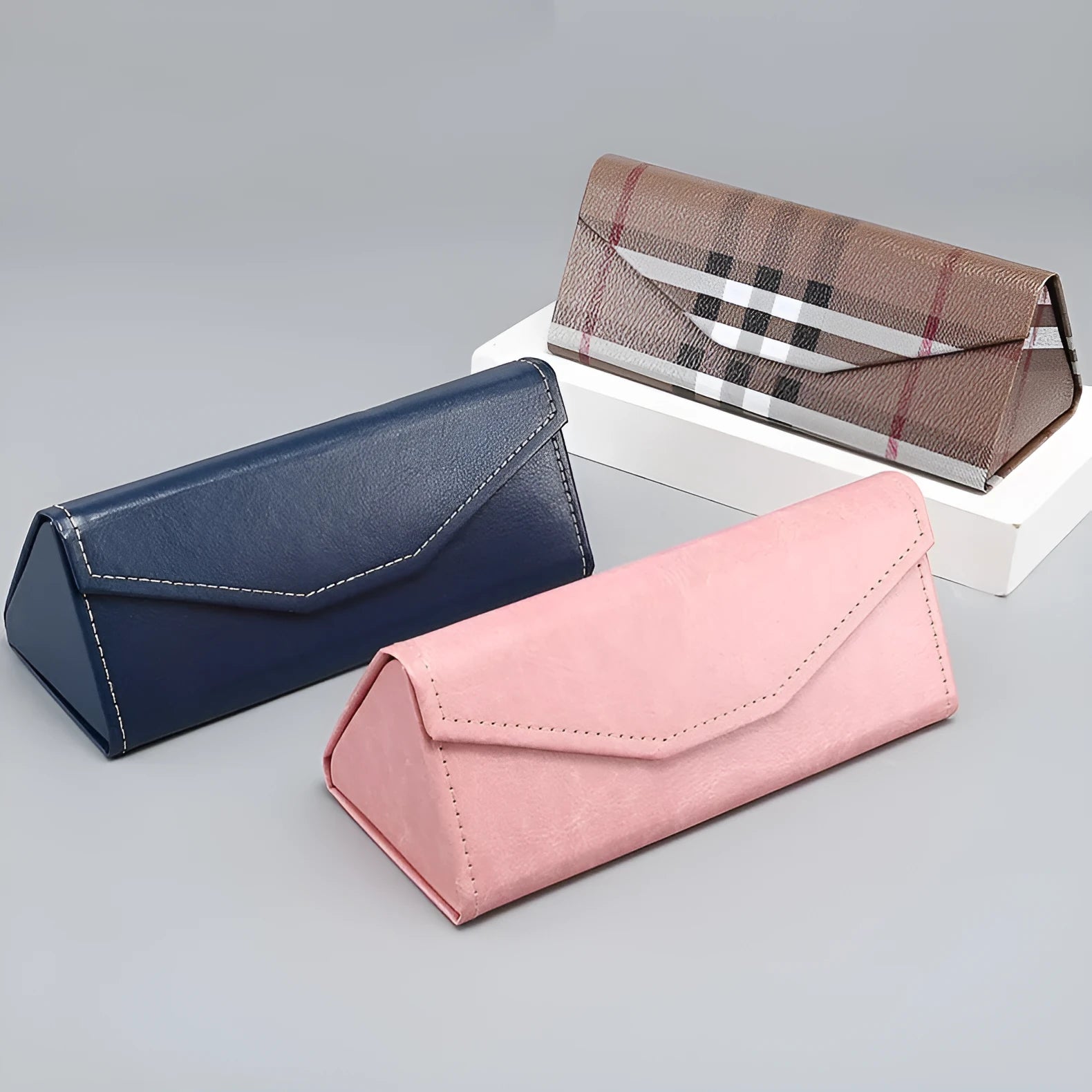 Triangle folding glasses case in compression-resistant cardboard with handmade stitching