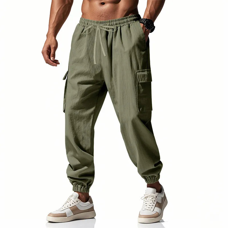 Men's ankle-tied loose fit linen casual trousers in army green, showing multiple pockets and drawstring waist.