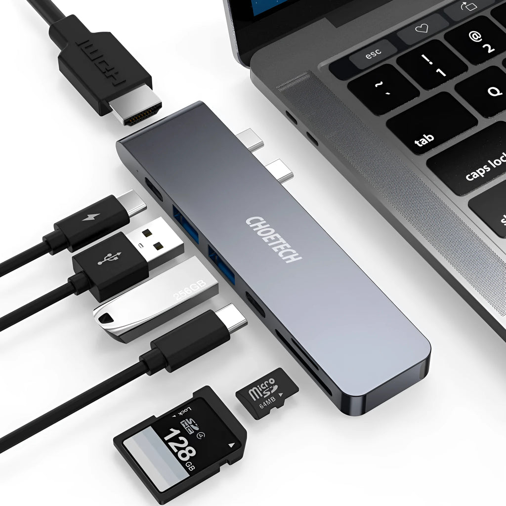 Compact silver USB-C multi-port adapter with SD card slot, HDMI, USB ports, and Thunderbolt 3 connector