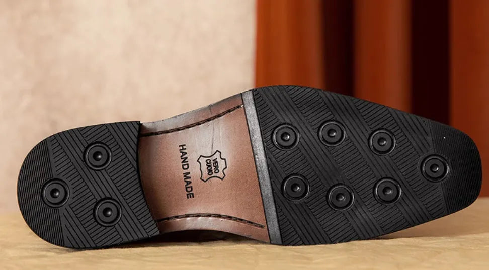 Men's black leather slip-on loafers with fringed detail and rubber sole