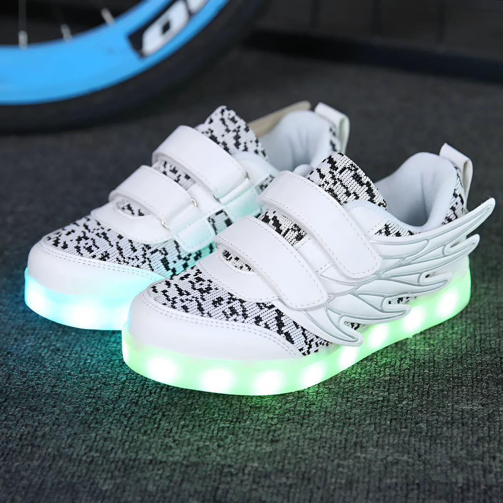 Children's plum red and white LED light up sneakers showing USB charging port and lights illuminated.