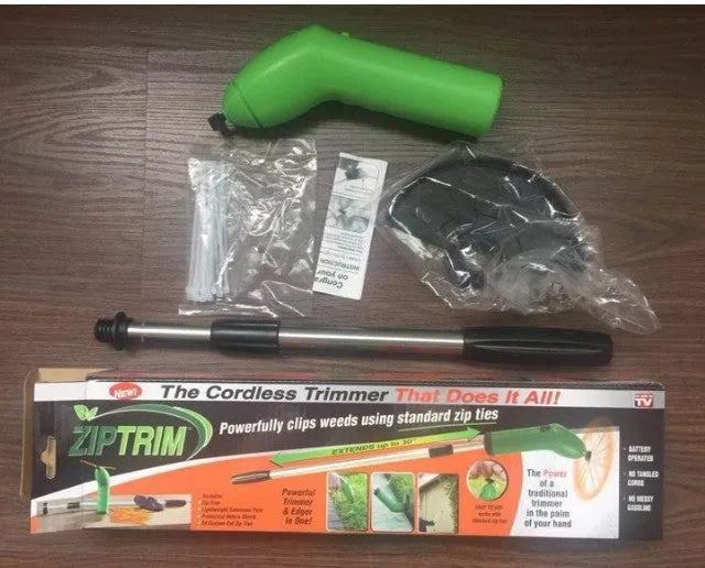 Cordless lawn trimmer weed trimmer with extension pole and debris shield on green grass
