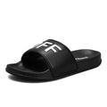Men's black open-toe slippers with a rubber sole, shown from the side.